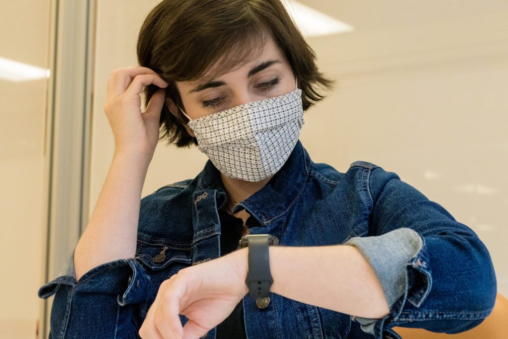 A woman looking at her smartwatch