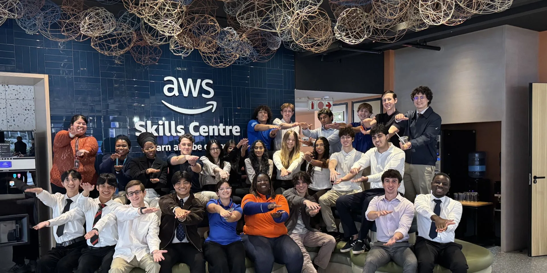 Students perform a Gator Chomp during their visit to the Amazon AWS Skills Centre in Cape Town, South Africa